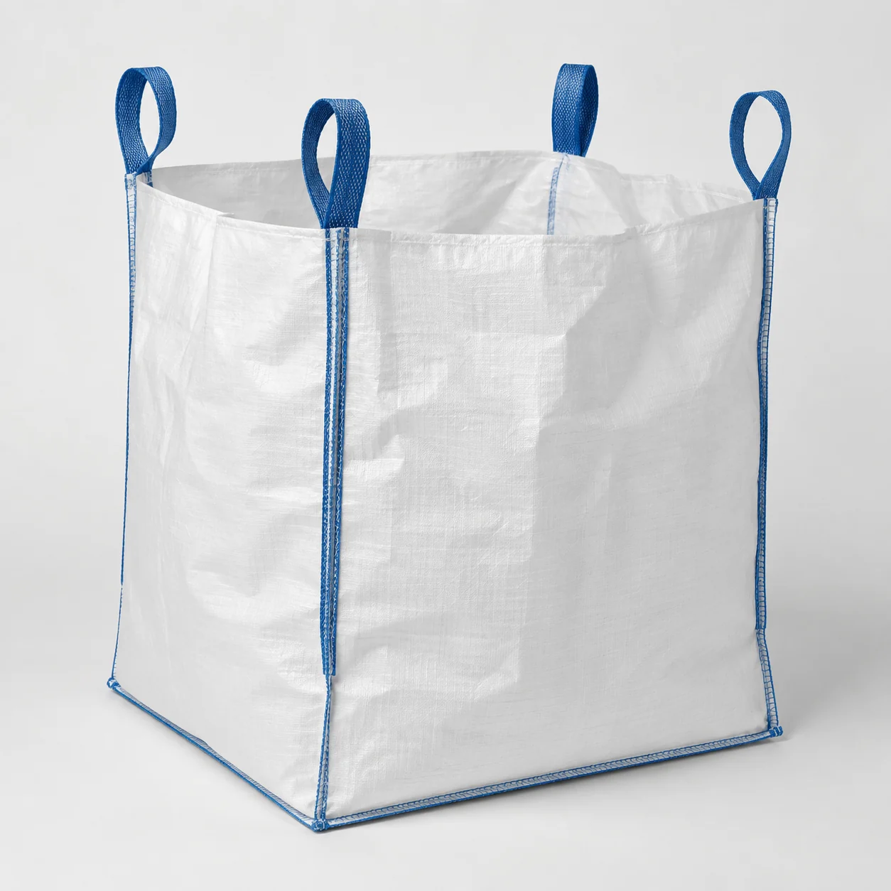 White woven FIBC with blue lifting loops on a clean studio background.