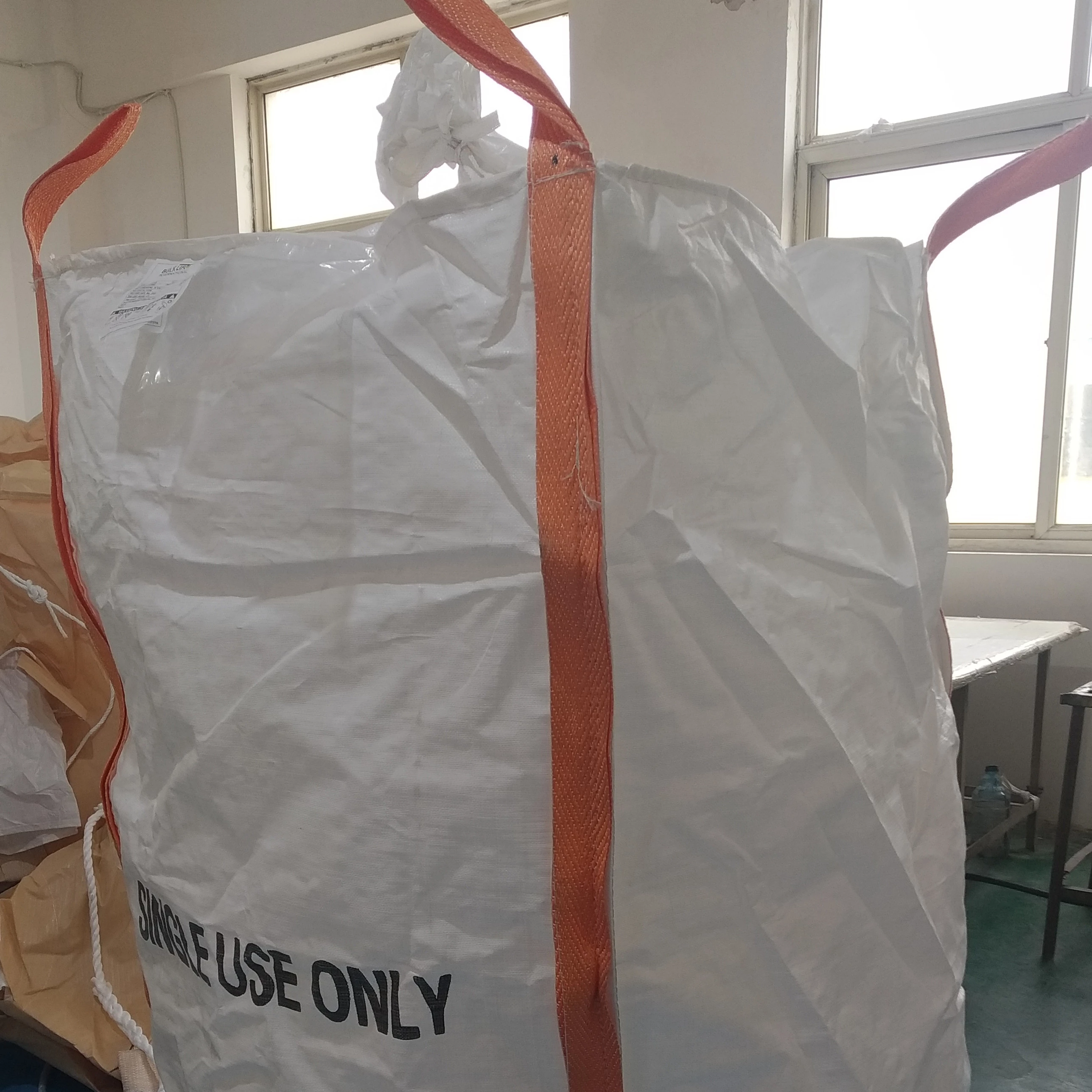 White bulk bag with orange lifting straps and SINGLE USE ONLY printed on the front.