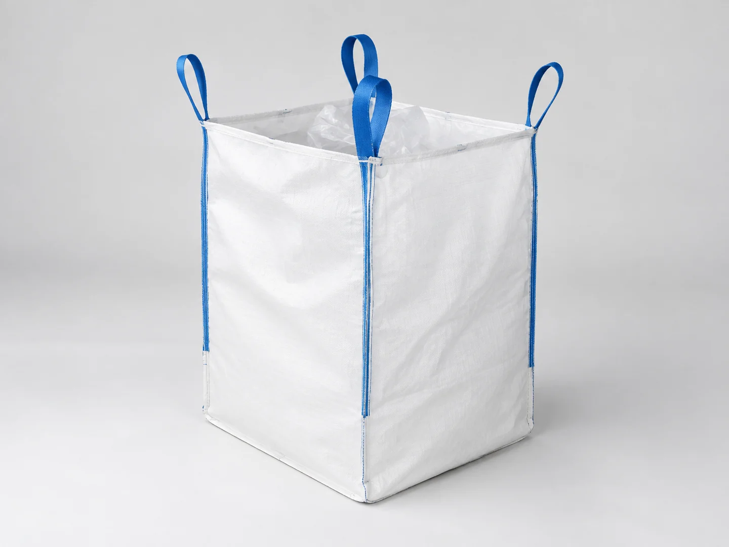 White U-panel FIBC bulk bag with four blue lifting loops and a clear inner liner, shown without printed branding.