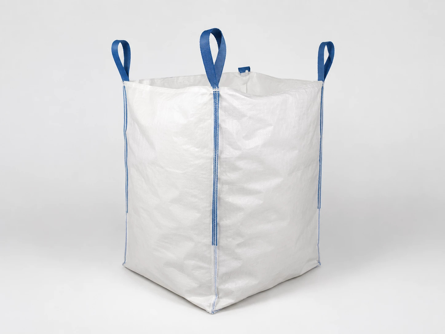 Unbranded white FIBC bulk bag with blue lifting loops for reviewing openings, seams and loop positions.